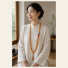 Amber & Blue Long Strand — young East Asian woman styling view Amber & Blue Long Strand — young East Asian woman styling view
