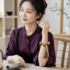 Bodhi Pattern Tassel Bracelet — young East Asian woman styling view Bodhi Pattern Tassel Bracelet — young East Asian woman styling view